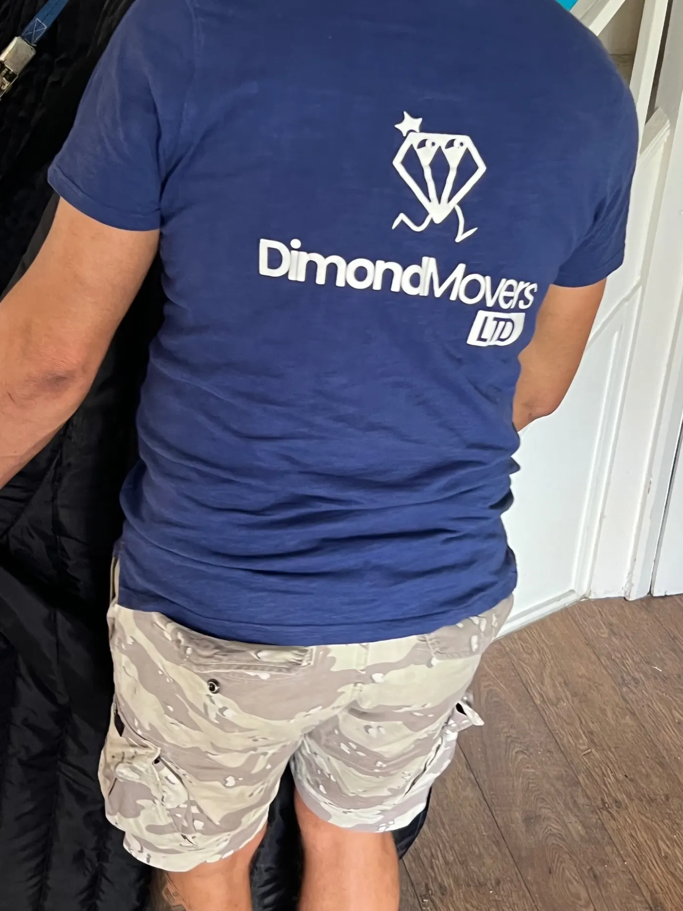 Dimond Movers branded uniform during a real piano move