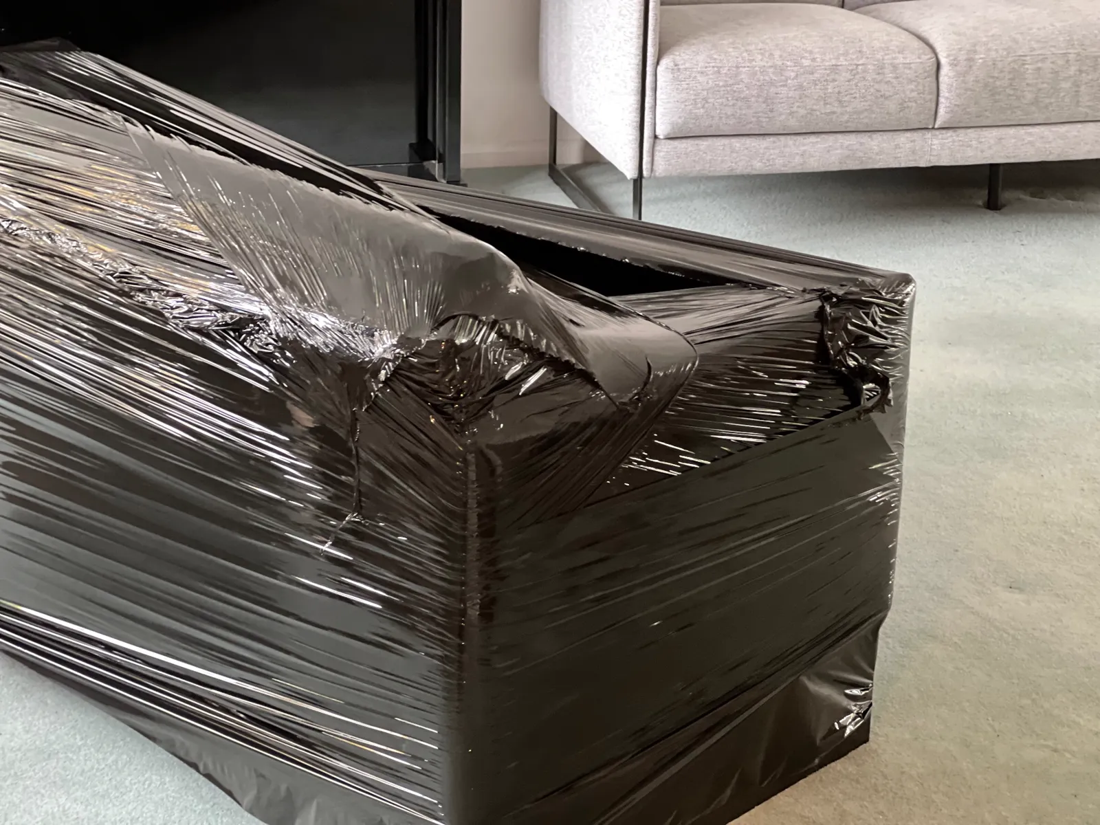 Furniture shrink-wrapped and protected with heavy moving film before a Dimond Movers transport