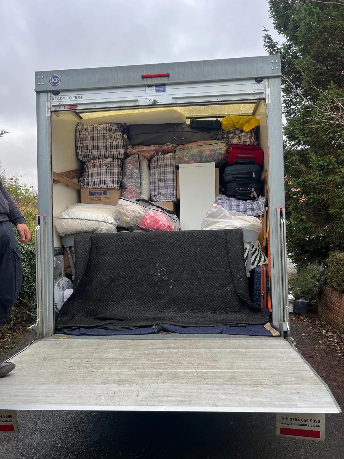 Luton removals van fully loaded by Dimond Movers — boxes, suitcases and blanket-wrapped furniture neatly stacked on the tail lift.