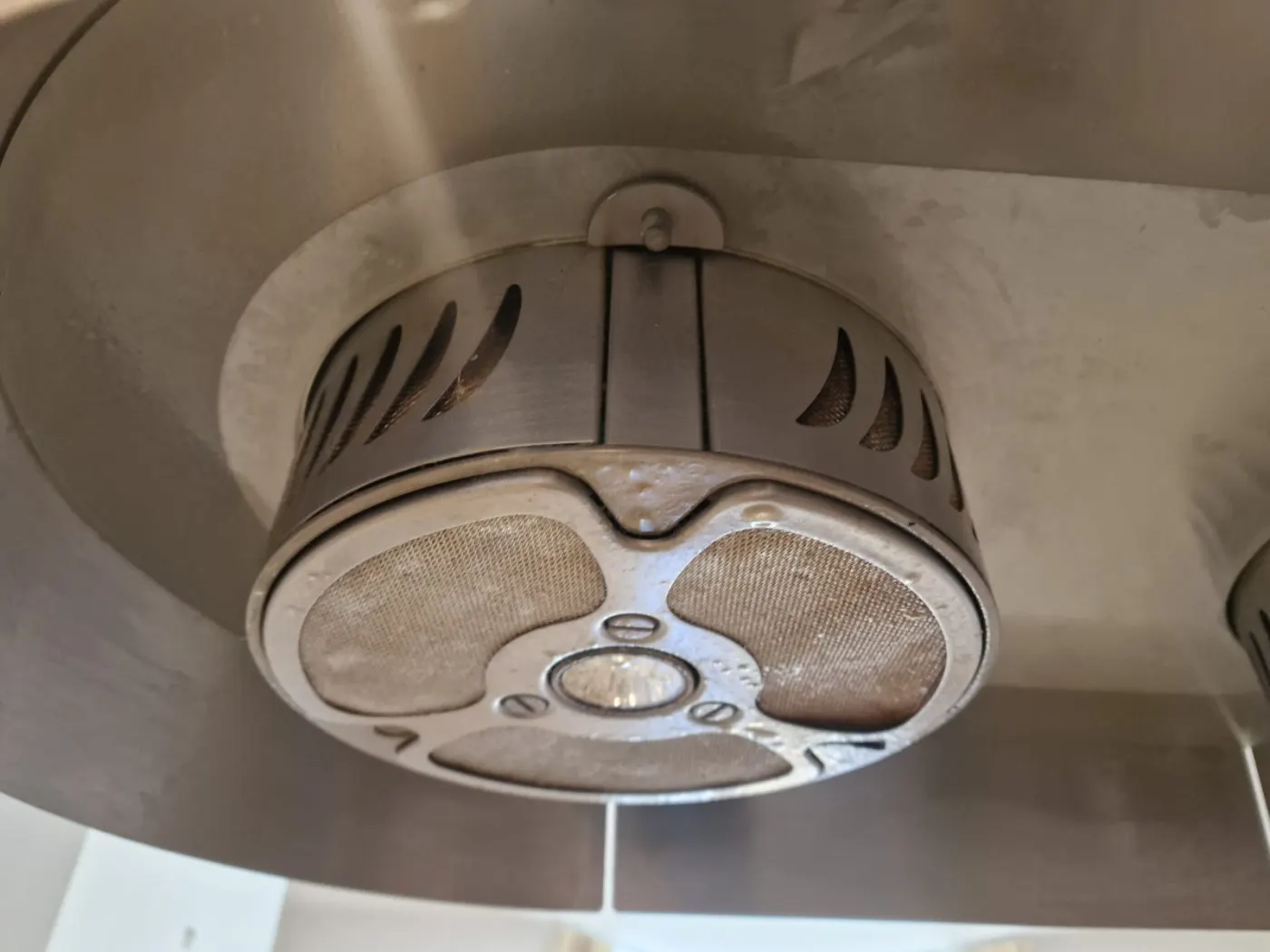 Greasy stainless-steel kitchen extractor hood filter before cleaning