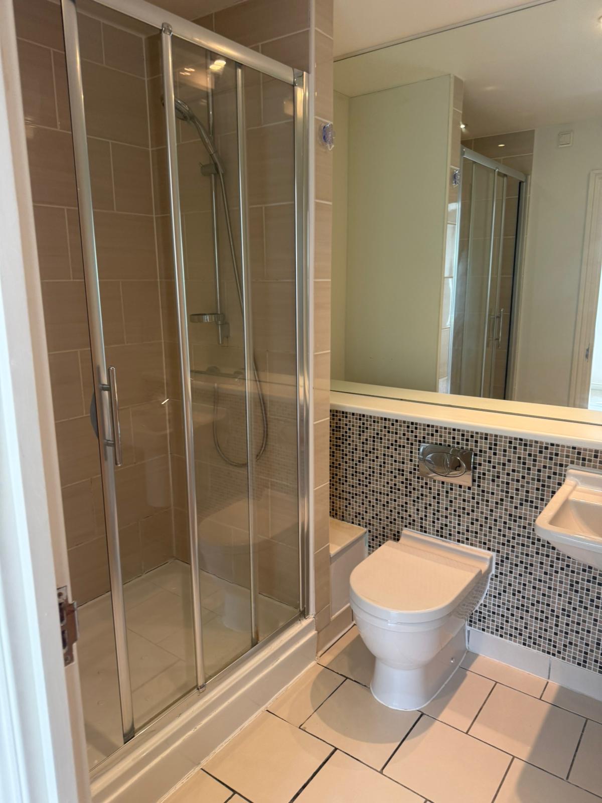 Spotless shower enclosure and tiled bathroom