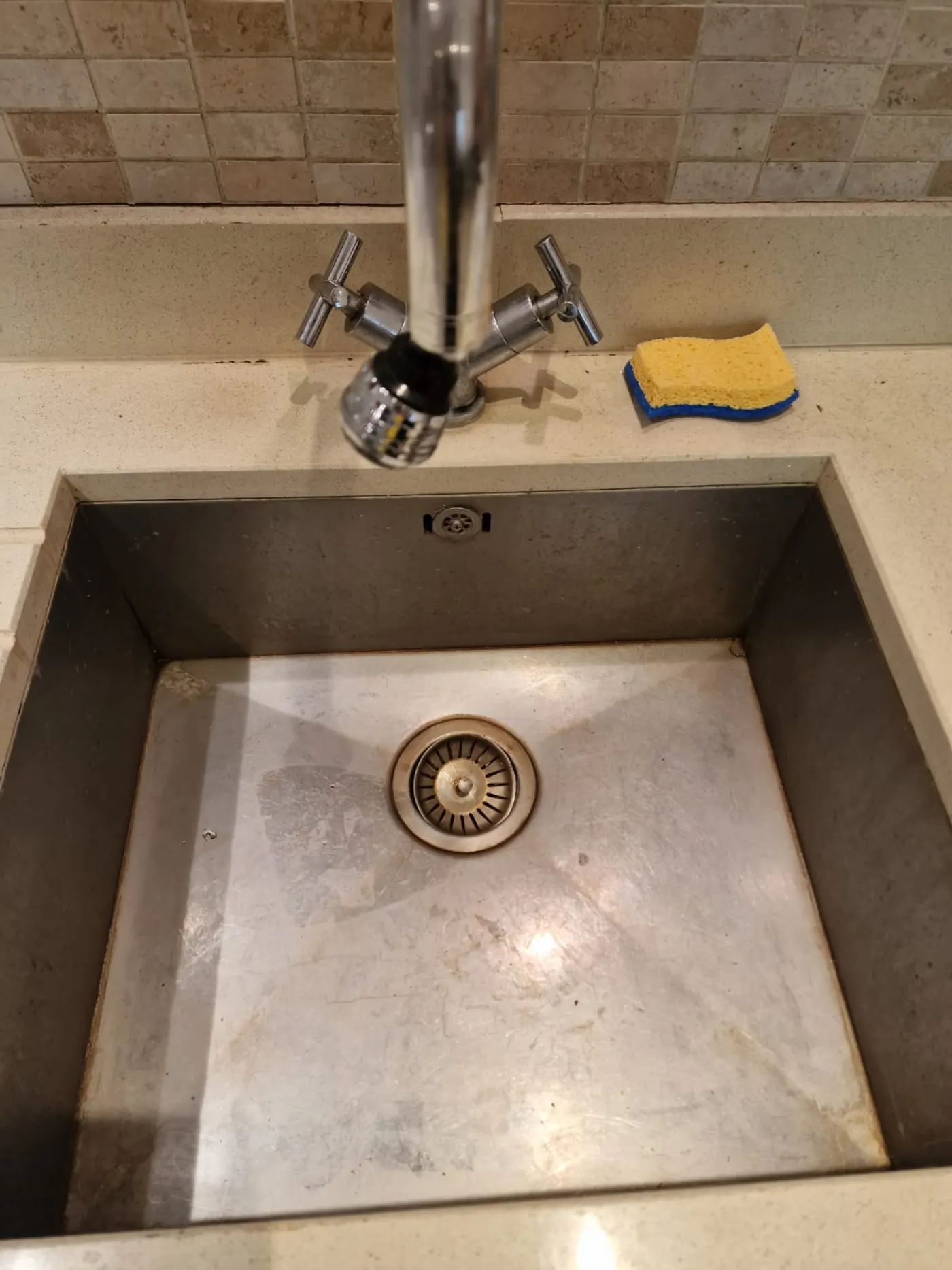 Stainless steel kitchen sink before limescale and grime removal